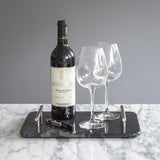 Charola de mármol negro con asas, sirviendo vino y copas